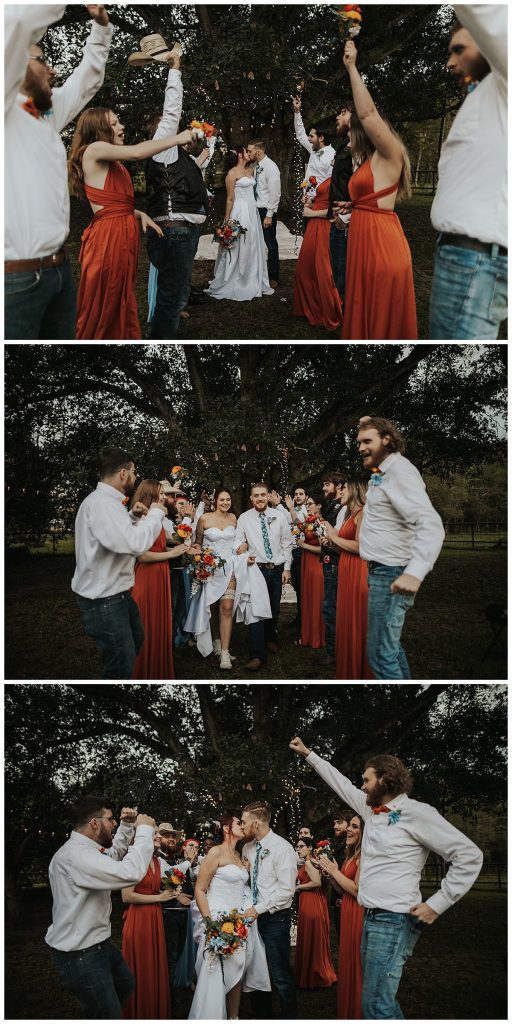 Wedding party cheering on the newly married couple